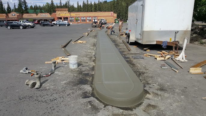 Freshly broomed concrete sidewalk with a curved end
