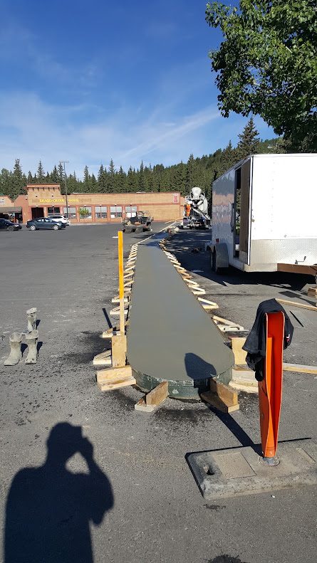 Concrete being placed in a sidewalk form on pour day